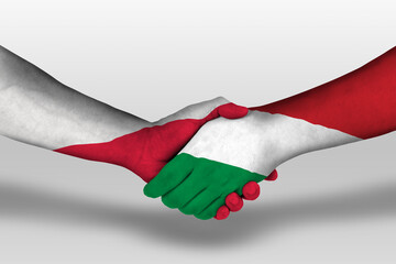 Handshake between hungary and poland flags painted on hands, illustration with clipping path.