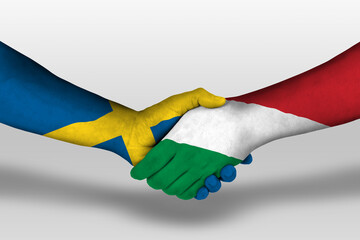 Handshake between hungary and sweden flags painted on hands, illustration with clipping path.