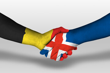 Handshake between iceland and belgium flags painted on hands, illustration with clipping path.