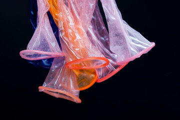 high-quality latex condoms in blue, orange, pink