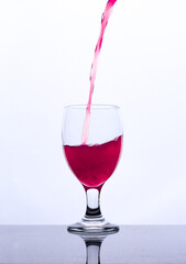 colored drink in a glass isolated white background