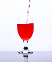 colored drink in a glass isolated white background
