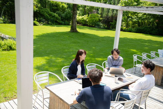 Men and Woman Having a Meeting on an Outdoor Office that Set Social Distancing as New Normal Office Style