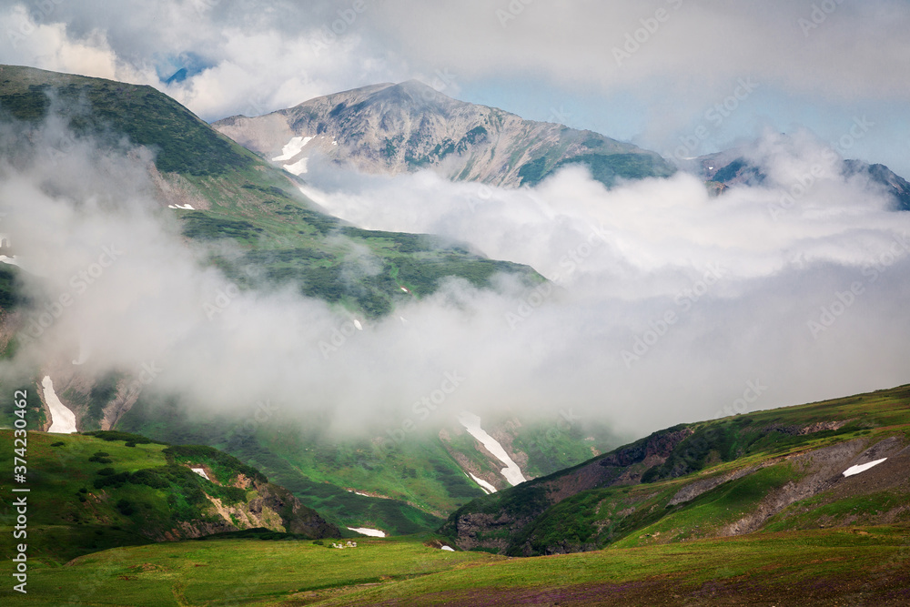 Wall mural Mountains drowning in fog