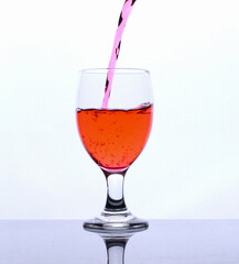 colored drink in a glass isolated white background