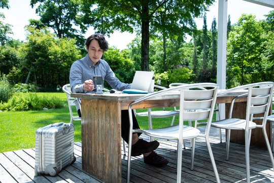 Mature Man are Working on an Outdoor Office that Set Social Distancing as New Normal Office Style