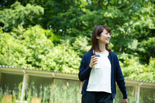 Mature Woman Walking in the Garden