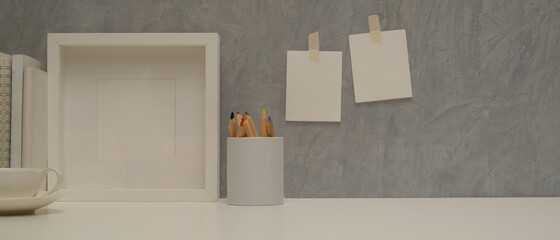 Worktable with copy space, mock up frame and stationery in home office