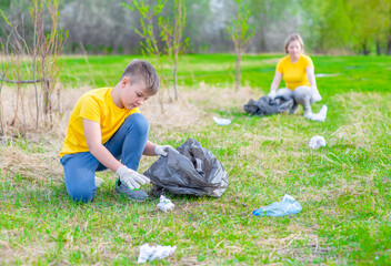 Group of a volunteers scavenges garbage in the summer park. Volunteer and ecology concept