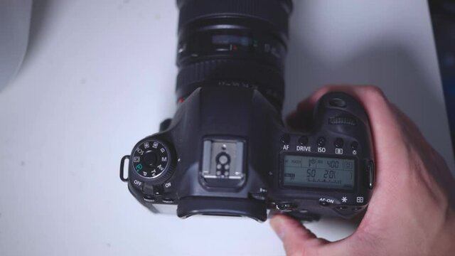 Person's Hand Setting The Quick Control Dial Of A Camera. - Close Up Shot