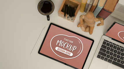 Naklejka premium Study table with mock up tablet, laptop, school elements, coffee mug and decoration