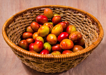 Fruit Basket Displaying Pile of Freshly Picked Red Plums 