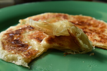 Baked Moroccan pancakes Rghaif, Msemen or Paratha. Cut side view close up.