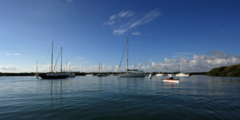 Fototapeta na wymiar Summer cloudscape over moored sailboats in Crandon Marina on Key Biscayne, Florida in early morning light.