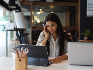Portrait of thoughtful female students doing homework