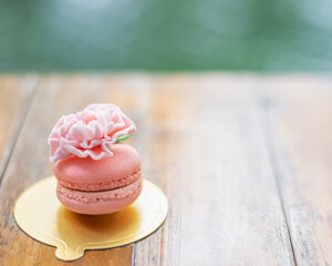 tasty macarons for breakfast  on a wooden table in the garden