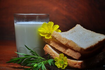 Dry rusk bread and a glass of milk isolated on wooden background. Healhty breakfast menu