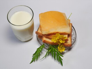 Dry rusk bread and a glass of milk isolated on white background. Healhty breakfast menu