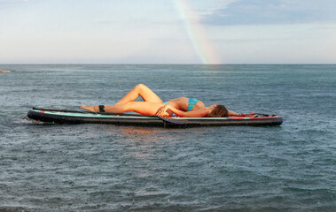 young girl on surfboard . sup 