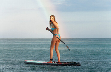 young girl on surfboard . sup 