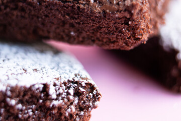 Delicious homemade brownies sprinkled with class sugar and stacked.