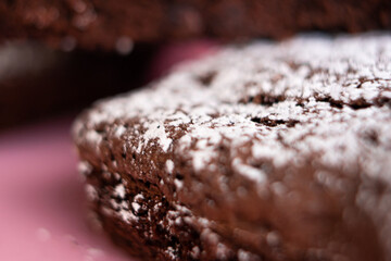 Delicious homemade brownies sprinkled with class sugar and stacked.