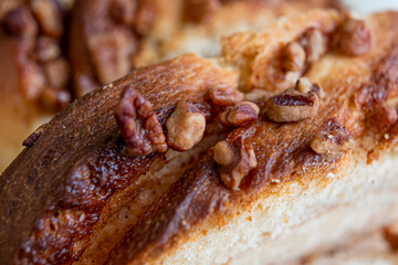 Delicious homemade walnut bread with sliced ​​walnuts pieces in close up.