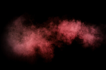 Red and pink powder explosion on black background. Colored powder cloud. Colorful dust explode. Paint Holi.