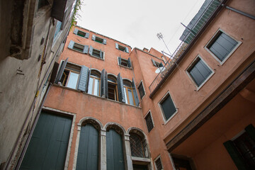 Architecture and facade of the old city buildings of Venice. Bottom view.