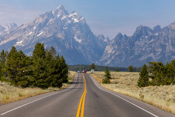 Fototapeta na wymiar Road Heading Into The Grand Teton Mountains In Wyoming 