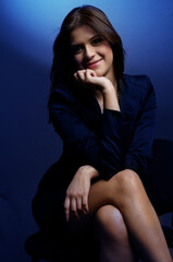 Young latina executive woman wearing a suit sitting looking confident