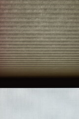 Paper curtains and blinds in a dark room.