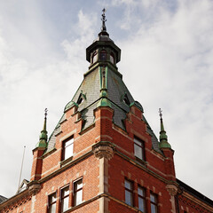Fototapeta na wymiar tower to an old red brick house in the center of Sundsvall