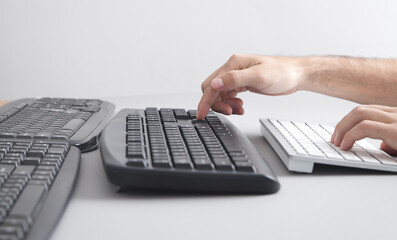 Man typing on computer keyboard.