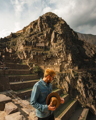 Man posing with Ollantaytambo in Peru