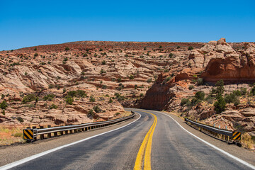 Open road through the field, highland road. Empty scenic highway in Arizona, USA. Desert highway at sunset, travel concept, USA.