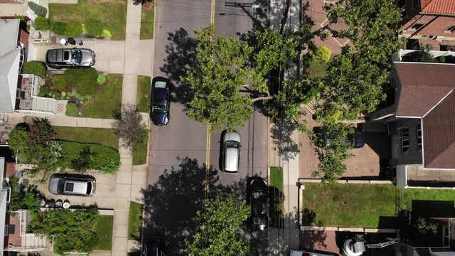 Aerial Shot of Car Driving in Suburbs