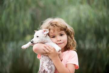 Hug friends. Happy child and dog hugs her with tenderness smiling.