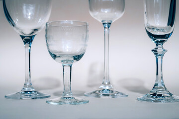 Wine glasses on a sunny table cast shadows, sunlight, crystal glassware, wine glasses, champagne flute.
