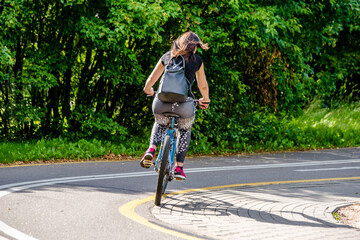 Naklejka premium Cyclist ride on the bike path in the city Park 
