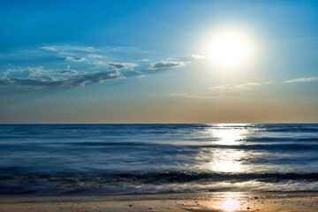 Naklejka na ściany i meble Sea sunset. Quiet calm sea. Sand beach.