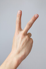 Man hand shows the number two. Countdown gesture or sign. Sign language.