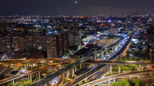 Aerial drone lapse view over the San Antonio freeway and the cityscape, during night time, in Mexico city, America - Reverse, hyperlapse shot