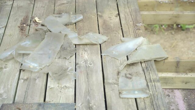 Gloved man grabs crow bar off deck