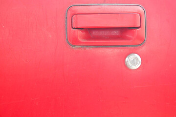 Car door - lock - old classic red car that is being repaired.