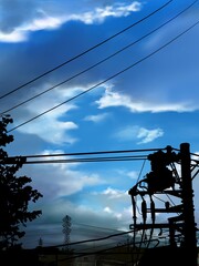 silhouette of high voltage power lines and cloudscape