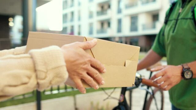Close up hands courier man give box woman customer outdoor service home package send holding purchase postal shipment express parcel slow motion