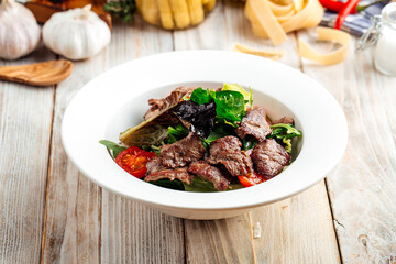 Closeup on roasted beef meat with vegetables