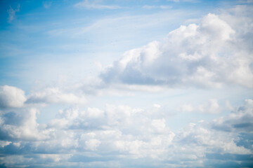 white cumulus clouds in the blue sky
