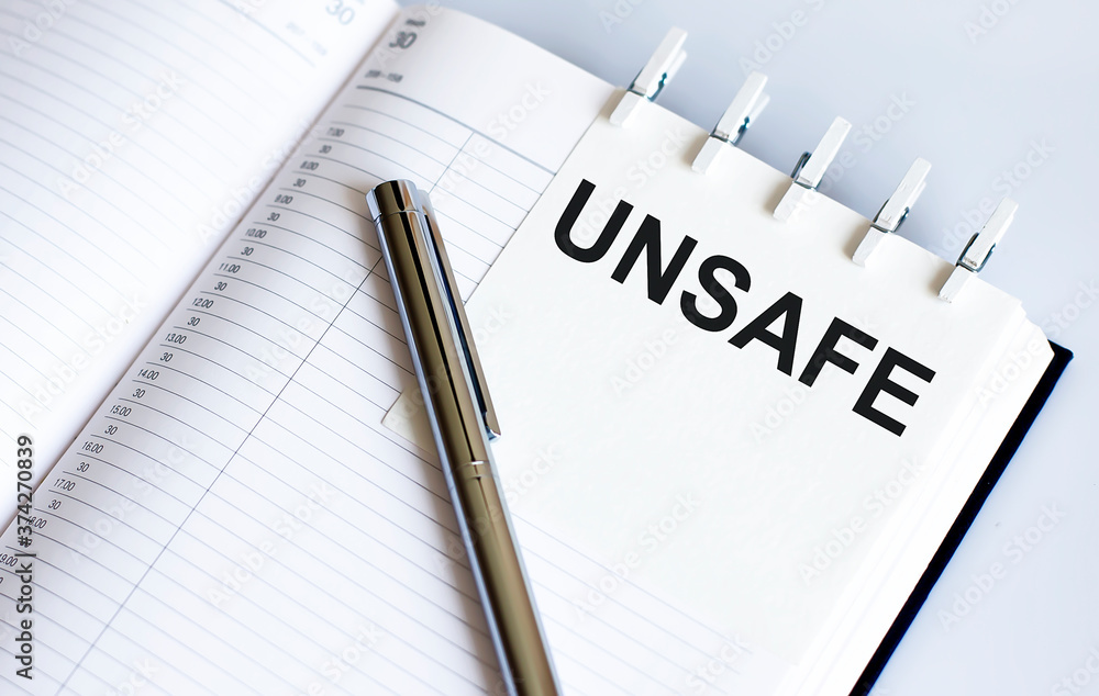 Poster unsafe on the short note texture background with pen